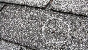 Hail damage on a roof marked